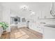 Bright, modern kitchen features white cabinets, stainless steel appliances, and stylish lighting at 1323 48Th N Ave, St Petersburg, FL 33703