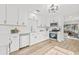 Beautiful kitchen featuring white cabinets, stainless steel appliances, and hardwood floors at 1323 48Th N Ave, St Petersburg, FL 33703