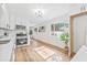 Modern kitchen boasts white cabinets, stainless steel appliances, and hardwood flooring at 1323 48Th N Ave, St Petersburg, FL 33703
