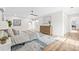 Spacious main bedroom features a large bed, wood floors, and a view to the bathroom at 1323 48Th N Ave, St Petersburg, FL 33703