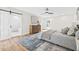 Cozy main bedroom with a ceiling fan, hardwood floors, and an ensuite bathroom with a glass shower at 1323 48Th N Ave, St Petersburg, FL 33703