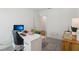 Bright home office with white walls, a modern desk, and natural light streaming through the window at 1497 Laredo Ave, Spring Hill, FL 34608