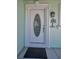 Close-up of the elegant front door with decorative glass and detailed trim, accented by a welcome sign at 14984 Cromwell Dr, Clearwater, FL 33764