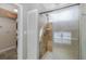 Updated shower featuring glass doors, neutral tile, and access to the laundry closet at 1702 E Knollwood St, Tampa, FL 33610