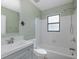 Bathroom with a tub and shower combination, white subway tile, and a modern vanity at 1702 E Knollwood St, Tampa, FL 33610