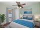 Green-painted bedroom featuring hardwood floors, a ceiling fan, and a window with wooden blinds at 1702 E Knollwood St, Tampa, FL 33610