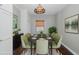 Cozy dining room features decor lighting and seating for six at 1702 E Knollwood St, Tampa, FL 33610