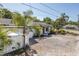 Cozy one-story home with a well-kept yard, featuring tropical plants and a fence at 1702 E Knollwood St, Tampa, FL 33610