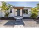 Curb view of single Gathering residence with a dark front door and well-kept landscaping at 1702 E Knollwood St, Tampa, FL 33610