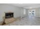 Bright living room with stone fireplace and view to back patio at 1702 E Knollwood St, Tampa, FL 33610