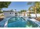 Backyard pool and shed with a white privacy fence and mature trees at 1702 E Knollwood St, Tampa, FL 33610