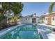 Backyard featuring a refreshing private swimming pool and outdoor entertaining area at 1702 E Knollwood St, Tampa, FL 33610