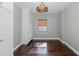 Room features hard wood flooring and vintage decor lighting at 1702 E Knollwood St, Tampa, FL 33610