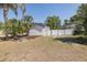 Property with well maintained yard featuring a privacy fence and tropical landscaping at 1702 E Knollwood St, Tampa, FL 33610