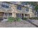 Back exterior view shows a two-story townhouse with a screened lanai, providing a private outdoor living space at 222 Draw Bridge Ln, Valrico, FL 33594