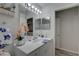 Bright bathroom with white vanity, large mirror, decorative lighting and a glimpse of the shower at 222 Draw Bridge Ln, Valrico, FL 33594