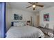 Relaxing bedroom with ceiling fan, comfortable bed, stylish decor, and wood-look flooring at 222 Draw Bridge Ln, Valrico, FL 33594