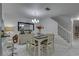 Bright dining room features a stylish table, chandelier and staircase at 222 Draw Bridge Ln, Valrico, FL 33594