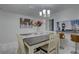 Inviting dining room features modern chandelier, breakfast bar and white marble floors at 222 Draw Bridge Ln, Valrico, FL 33594