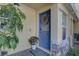 Inviting front door with a decorative wreath, complemented by lush greenery at 222 Draw Bridge Ln, Valrico, FL 33594