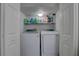 A conveniently located laundry area with front-load washer and dryer, with organized storage solutions, and easy access at 222 Draw Bridge Ln, Valrico, FL 33594