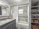 Bathroom features a shower over tub, tiled walls, and vanity with granite countertop at 2235 Burlington N Ave, St Petersburg, FL 33713