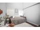 Sunlit bedroom featuring a daybed with a shaggy rug, and decorative lamps and tables at 2235 Burlington N Ave, St Petersburg, FL 33713