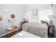 Light filled bedroom with a daybed, small table and rug, with lamps and wall decorations at 2235 Burlington N Ave, St Petersburg, FL 33713