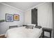 Cozy bedroom features a comfortable bed with decorative pillows, art and window at 2235 Burlington N Ave, St Petersburg, FL 33713
