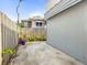 Long driveway with a concrete surface and a wooden fence border in the home's backyard area at 2235 Burlington N Ave, St Petersburg, FL 33713