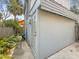 Exterior view of home featuring a side door, concrete path and tropical landscaping around the perimeter at 2235 Burlington N Ave, St Petersburg, FL 33713