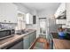 Kitchen with updated counters and hardware, featuring a sink with modern appliances, leading into the bathroom at 2235 Burlington N Ave, St Petersburg, FL 33713