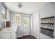 Well lit mud room includes white dresser, door to outside, and large storage closet at 2235 Burlington N Ave, St Petersburg, FL 33713