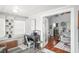 Sunroom with desk and view into living room featuring vaulted ceilings and hardwood flooring at 2235 Burlington N Ave, St Petersburg, FL 33713