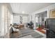 Bright sunroom with desk space, large windows, and a view into the living area with hardwood floors at 2235 Burlington N Ave, St Petersburg, FL 33713
