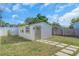 Backyard featuring green grass and an outdoor structure with an exterior door at 2511 18Th N Ave, St Petersburg, FL 33713