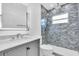 Bathroom with a modern vanity, illuminated mirror, and a shower with stylish gray tile at 2511 18Th N Ave, St Petersburg, FL 33713