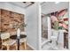 Cozy area with brick wall, small table and chairs, and access to modern bathroom at 2511 18Th N Ave, St Petersburg, FL 33713