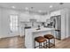 Modern kitchen with stainless steel appliances, a large island with seating, and stylish pendant lighting at 2511 18Th N Ave, St Petersburg, FL 33713