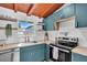 Modern kitchen with blue cabinets, wood countertops, and an electric range oven at 2511 18Th N Ave, St Petersburg, FL 33713