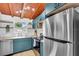 Modern kitchen features stainless steel appliances, blue cabinets, butcher block counters, and wood ceiling at 2511 18Th N Ave, St Petersburg, FL 33713