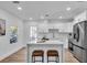 Modern kitchen features stainless steel appliances, a large island with seating, and stylish pendant lighting at 2511 18Th N Ave, St Petersburg, FL 33713