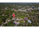 An aerial perspective shows the location within a community featuring mature trees, a tennis court, and pool at 2627 2Nd Ct, Palm Harbor, FL 34684