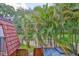 Overlooking a lush green landscape with a tile roof and palm trees on the horizon at 2627 2Nd Ct, Palm Harbor, FL 34684