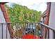 Charming balcony view overlooking a gazebo and patio, surrounded by lush greenery and red outdoor carpet at 2627 2Nd Ct, Palm Harbor, FL 34684