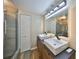Modern bathroom with double sinks, updated fixtures, and a glass-enclosed shower for a spa-like experience at 2627 2Nd Ct, Palm Harbor, FL 34684