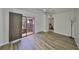 Bedroom with wood-look floors, a sliding glass door to a balcony, and access to the hallway at 2627 2Nd Ct, Palm Harbor, FL 34684