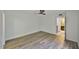 A bright, open bedroom featuring wood-look floors, access to the bathroom, and natural light at 2627 2Nd Ct, Palm Harbor, FL 34684