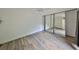 A spacious bedroom with wood-look floors and a large mirrored closet providing ample storage space at 2627 2Nd Ct, Palm Harbor, FL 34684