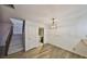 Dining space next to the staircase featuring wood-look flooring and decorative lighting at 2627 2Nd Ct, Palm Harbor, FL 34684